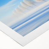 Rolled canvas artwork showcasing a vibrant countryside landscape with rolling hills and a blue sky, elegantly packaged in a protective cardboard tube for safe delivery.
