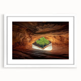 Framed landscape artwork depicting a serene cave scene, featuring a white matting and a sleek black frame for an elegant display, ideal for home decor.