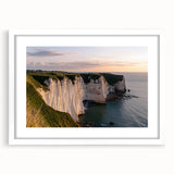 Framed landscape art featuring dramatic cliffs and serene ocean views, presented with a white mat for a clean aesthetic, perfect for enhancing modern home decor.