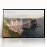 Framed acrylic artwork showcasing a dramatic cliff landscape with vibrant colors, displayed in a sleek black frame, ideal for modern home decor.