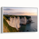 Framed canvas artwork depicting dramatic cliffs and landscapes, showcasing natural colors and textures, perfect for home or office decor. White frame enhances visual appeal.