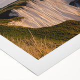 Stunning landscape canvas print showcasing dramatic cliffs against a vibrant sunset, ideal for modern home decor, packaged securely in a protective tube.