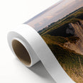 Stunning landscape canvas print showcasing vibrant cliffs and serene ocean views, expertly rolled and packaged in a protective cardboard tube for easy display.