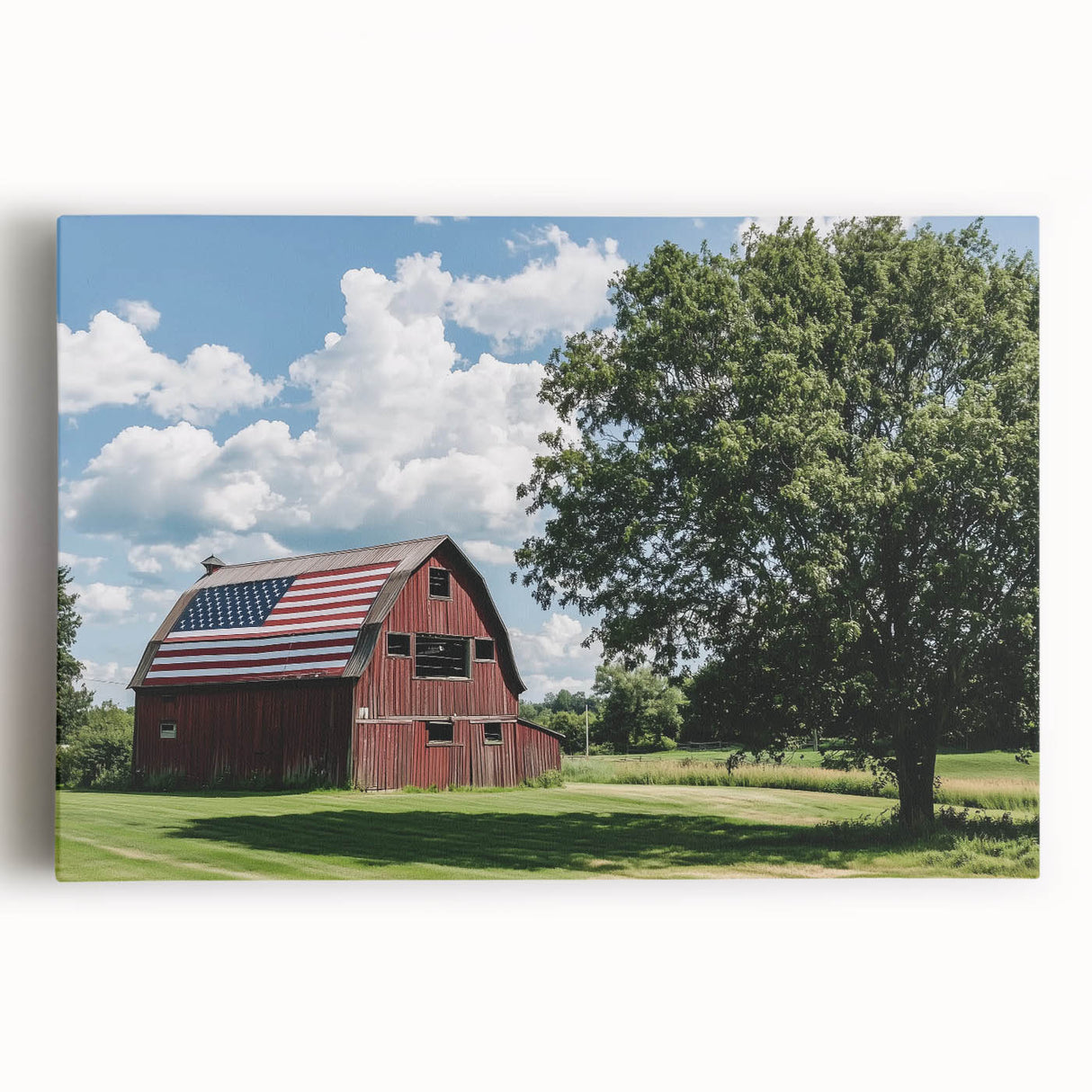 Stretched canvas artwork depicting a serene landscape scene with a rustic barn surrounded by vibrant green fields and a bright blue sky, ideal for home decor.