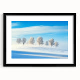 Black-framed landscape artwork displaying a serene countryside scene, featuring lush green fields and a vibrant sky, perfect for home decor.