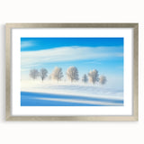 Silver-framed landscape art print showcasing a serene countryside scene with vibrant greenery and a clear blue sky, elegantly matted for a polished look. Perfect for enhancing home decor with a touch of nature.