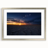 Silver-framed landscape artwork showcasing a vibrant desert scene with striking colors and textures, elegantly matted for enhanced presentation, perfect for home decor.