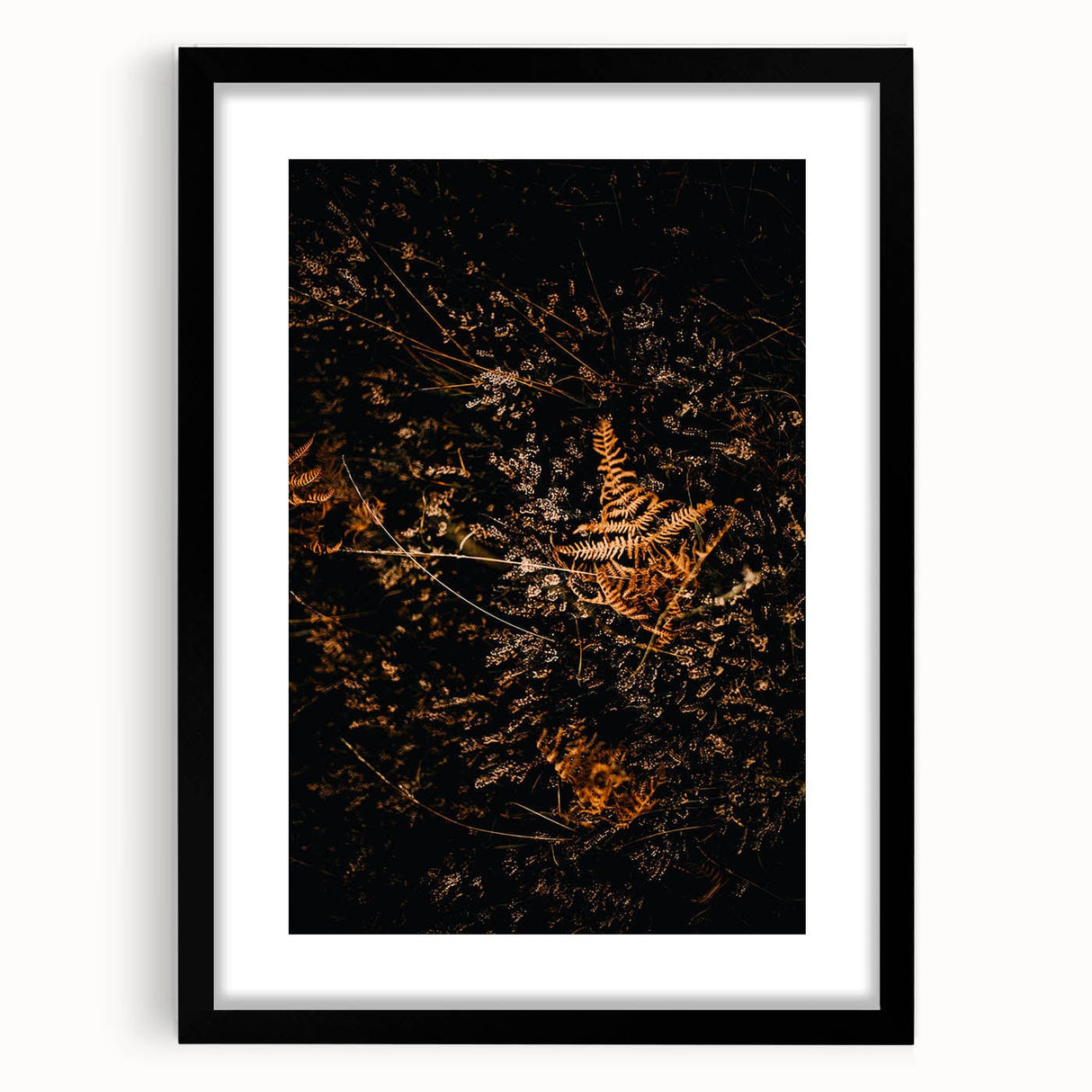 Abstract art print featuring vibrant autumn colors on a textured canvas, framed in black, ideal for living room decor.