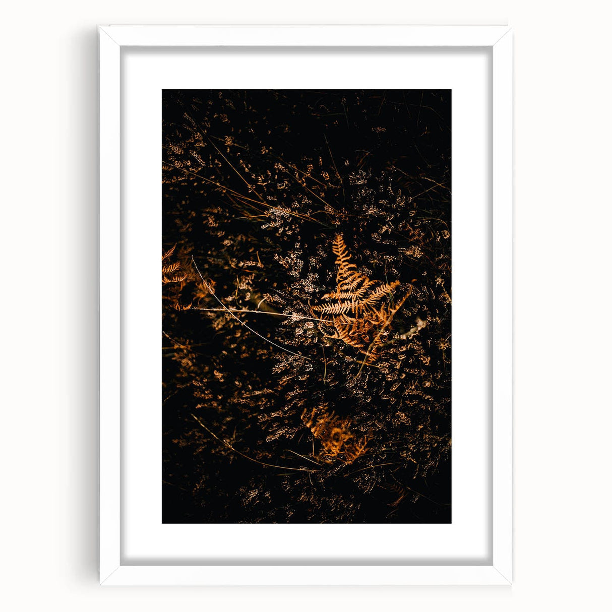 Abstract art print featuring warm autumnal hues on a white framed canvas, ideal for dining room decor.