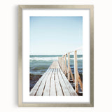 Textured abstract art print in silver frame, featuring dynamic swirl patterns in soft gray and white.