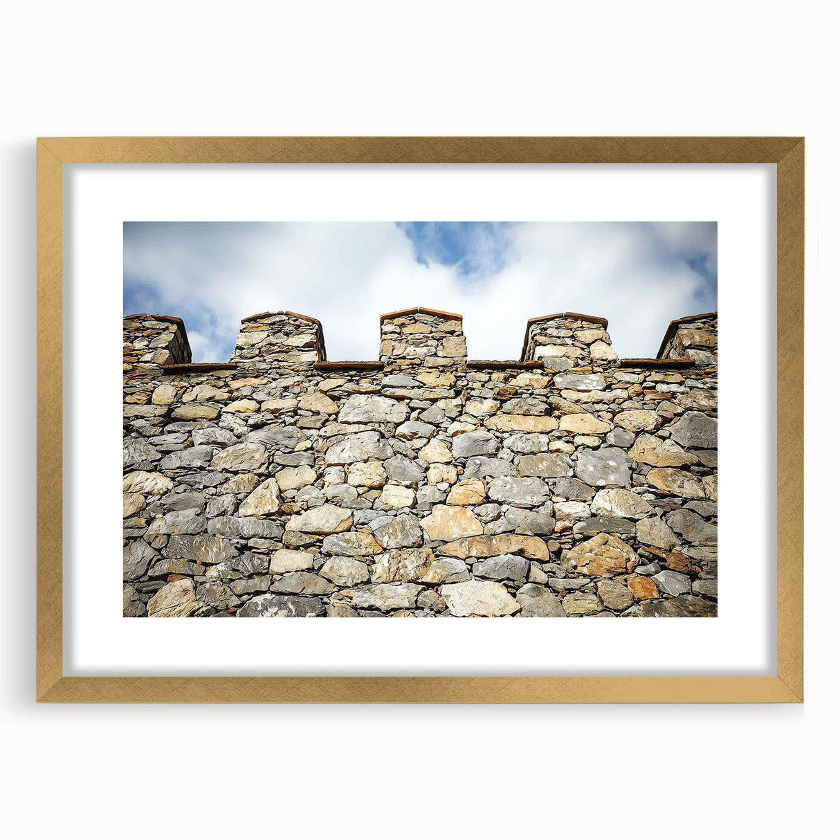 Framed landscape artwork featuring a picturesque castle scene in vibrant colors, accented with a gold mat border, ideal for home decor or office enhancement.