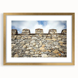 Framed landscape artwork featuring a picturesque castle scene in vibrant colors, accented with a gold mat border, ideal for home decor or office enhancement.