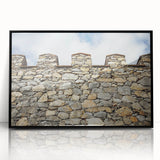 Framed acrylic artwork showcasing a stunning landscape of a medieval castle surrounded by lush greenery, presented in a sleek black frame, perfect for home decor.