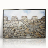 Framed acrylic artwork showcasing a picturesque landscape with a majestic castle, set against a serene backdrop of rolling hills and blue skies, perfect for home decor.