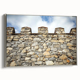 Framed canvas artwork showcasing a stunning landscape with a castle, elegantly displayed with a silver frame, perfect for home decor and enhancing interior aesthetics.
