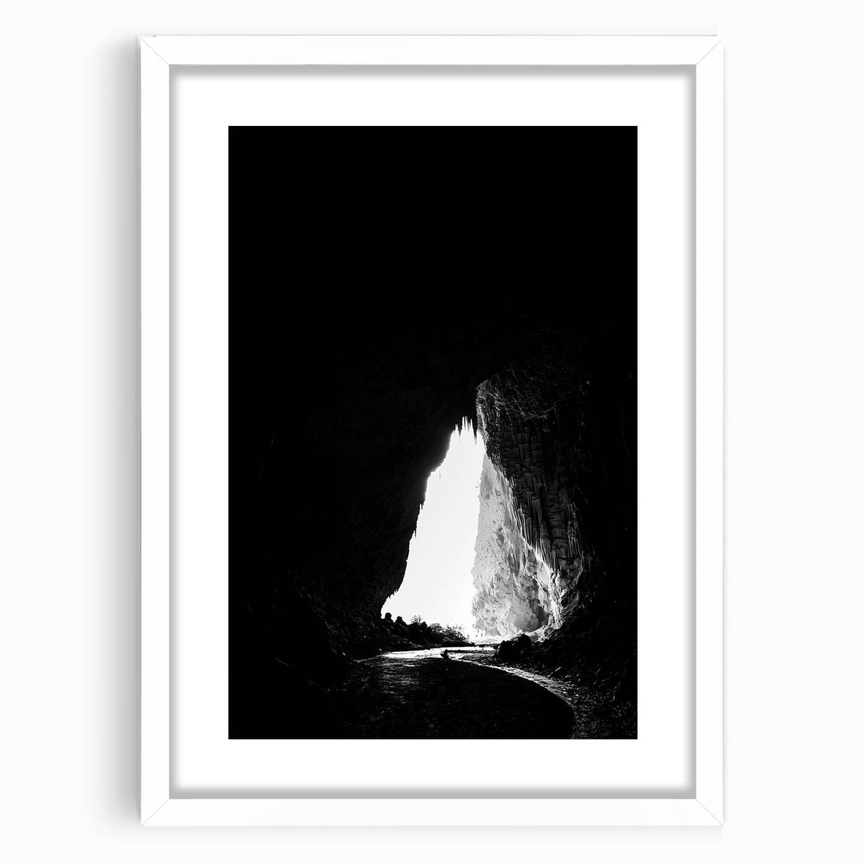 Framed landscape artwork depicting a serene cave scene, featuring earthy tones and textures, complemented by a white mat for an elegant presentation. Perfect for home decor and nature enthusiasts.
