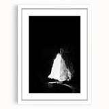 Framed landscape artwork depicting a serene cave scene, featuring earthy tones and textures, complemented by a white mat for an elegant presentation. Perfect for home decor and nature enthusiasts.