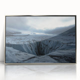 Framed acrylic artwork showcasing a dramatic landscape with towering cliffs and vibrant colors. The silver frame enhances the piece, perfect for modern decor.