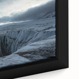 Close-up view of a framed canvas artwork depicting a dramatic cliff landscape, featuring vibrant colors and intricate details, ideal for home decor.