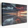 Stretched canvas artwork depicting a serene landscape featuring a picturesque bridge, vibrant greenery, and a clear blue sky, ideal for home decor.