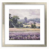 Framed landscape wall art depicting a serene countryside scene, featuring lush green fields and a clear blue sky, elegantly presented with a silver mat for a sophisticated look.
