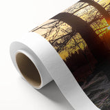 Vibrant rolled canvas showcasing a serene countryside landscape with lush green fields and a clear blue sky, elegantly packaged in a protective cardboard tube.
