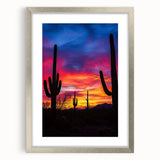 Framed desert landscape artwork with a silver mat, showcasing warm earth tones and vibrant sunset hues, ideal for enhancing modern home decor.