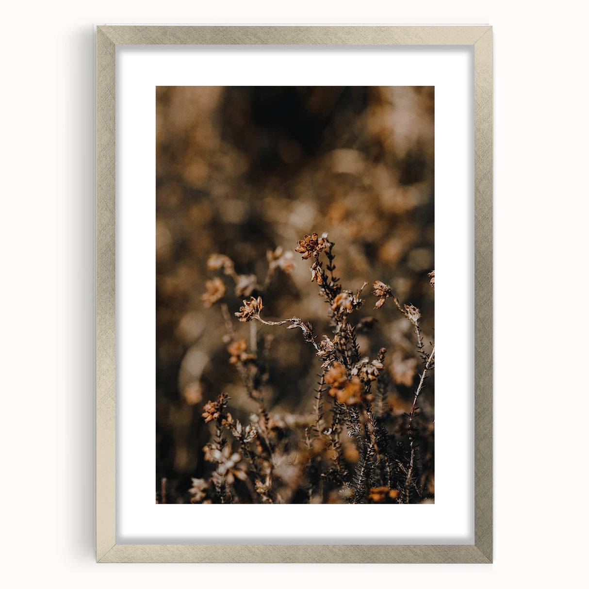 Textured abstract art print in orange and red tones on a silver-framed canvas, suitable for bedroom decor.