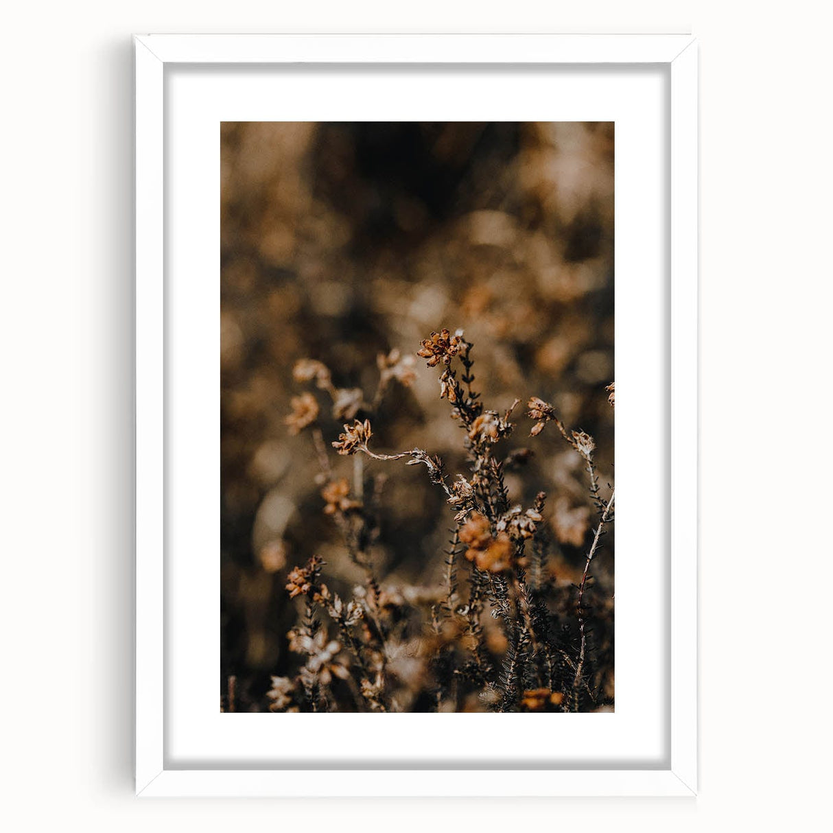 Abstract art print featuring swirling autumnal hues in a white frame, suitable for bedroom or dining room decor.