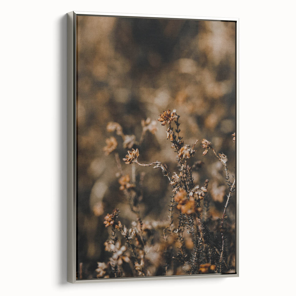 Framed canvas of a vintage-style landscape painting featuring fall scenery in muted orange and brown tones.