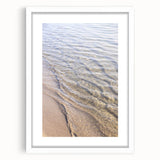 Abstract art print featuring dynamic swirls in orange and yellow tones, framed in white, ideal for dining room decor.