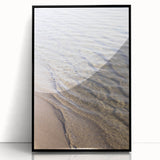 Large abstract wall art on acrylic, featuring swirling blue and white patterns, framed in black.