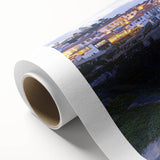 Vibrant rolled canvas artwork showcasing a dramatic cliff landscape with lush greenery and a clear blue sky, elegantly packaged in a protective cardboard tube.