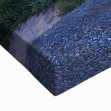 Close-up of a stretched canvas print showcasing a vibrant landscape with dramatic cliffs and rich colors, perfect for home decor or art enthusiasts.