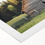 Rolled canvas showcasing a vibrant landscape barn design, featuring rich colors and intricate details, carefully packaged in a protective cardboard tube for shipping.