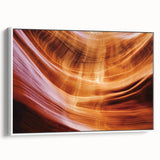 Framed canvas artwork depicting a serene landscape of canyons with soft earth tones and vibrant skies, ideal for home decor and art enthusiasts. The white frame enhances the natural beauty of the scene, making it a perfect addition to modern interiors.