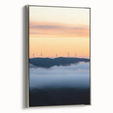 Framed canvas artwork showcasing a serene countryside landscape with vibrant green fields and a blue sky, elegantly bordered in silver, ideal for home decor.