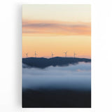 Stretched canvas artwork depicting a serene countryside landscape with rolling hills, vibrant green fields, and a clear blue sky, perfect for home decor.