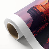 Desert landscape rolled canvas artwork showcasing vibrant orange and warm earth tones, featuring striking canyon formations under a clear blue sky, perfect for home decor.