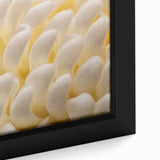 Close-up of black framed canvas featuring a textured floral design in vibrant colors, ideal for living room decor.