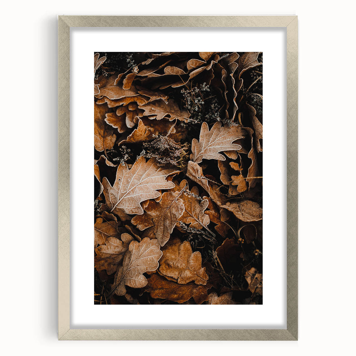 Textured abstract art print depicting autumnal hues in a silver frame, ideal for bedroom wall decor.