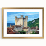 Elegant gold-framed landscape artwork showcasing a picturesque castle scene, complete with a decorative mat, perfect for enhancing home decor or gallery displays.