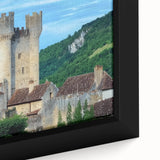 Close-up view of a framed canvas artwork depicting a vibrant landscape with a majestic castle surrounded by lush greenery and a blue sky, ideal for home decor.