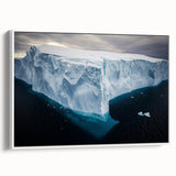 Framed canvas artwork depicting a scenic landscape with dramatic cliffs and a serene sky, presented in a sleek white frame, perfect for home decor.