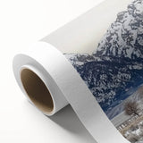 Rolled canvas showcasing a vibrant landscape barn scene with rich colors and intricate details, securely packaged in a durable cardboard tube for safe shipping.