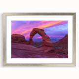 Framed landscape artwork of canyons in vibrant colors, featuring a silver mat and frame, ideal for adding a touch of nature to home decor.