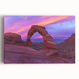 Stretched canvas artwork depicting a vibrant landscape of canyons in warm hues of orange and red, perfect for home decor or art enthusiasts seeking natural scenery.