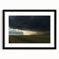 Black-framed landscape artwork depicting a serene countryside scene, featuring green fields and a blue sky, designed for elegant home decor and framing.