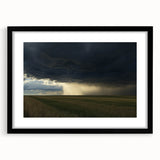 Black-framed landscape artwork depicting a serene countryside scene, featuring green fields and a blue sky, designed for elegant home decor and framing.
