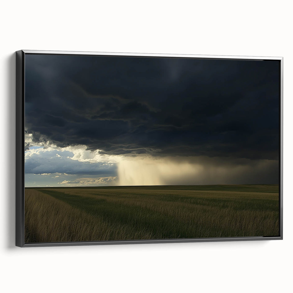 Framed canvas artwork depicting a serene countryside landscape, showcasing vibrant green fields and a clear blue sky, presented with a sleek black frame.
